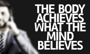 Business man with the text The Body Achieves What the Mind Believes in a concept image